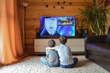 Two children watching TV.